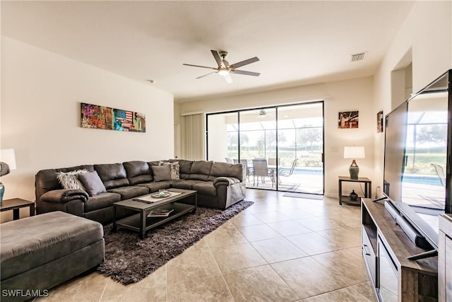 living room with ceiling fan and light tile patterned floors