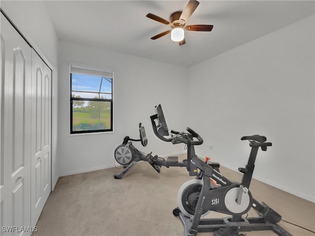 workout area featuring ceiling fan and light colored carpet