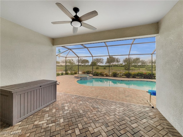 view of pool with glass enclosure, a patio, and an in ground hot tub