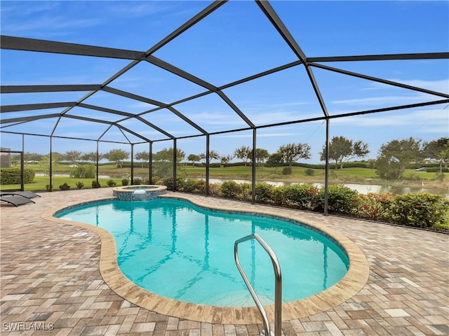 view of pool featuring a patio, glass enclosure, and an in ground hot tub