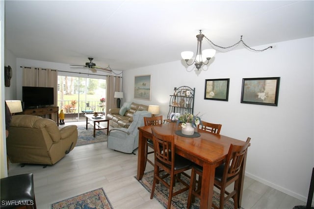 dining space featuring a chandelier and light hardwood / wood-style flooring