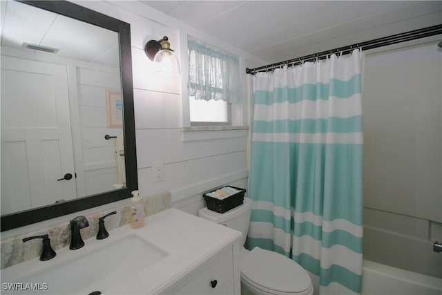 full bathroom featuring shower / tub combo, vanity, and toilet