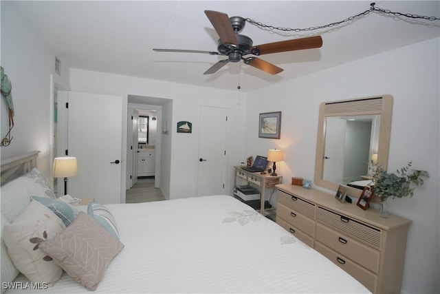 bedroom with ceiling fan and ensuite bath