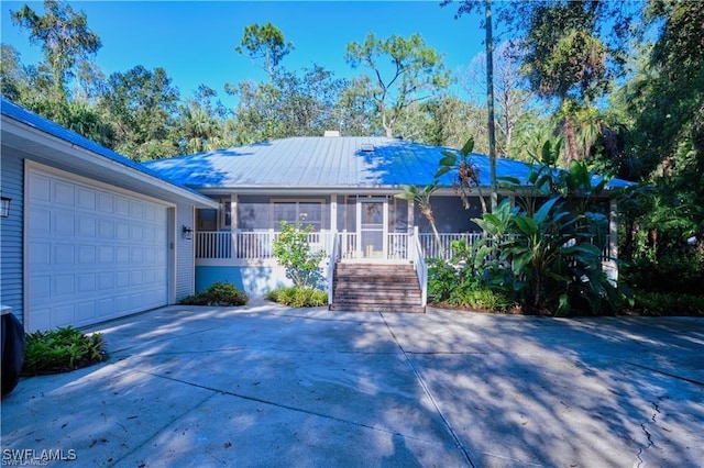 single story home with a garage and a sunroom