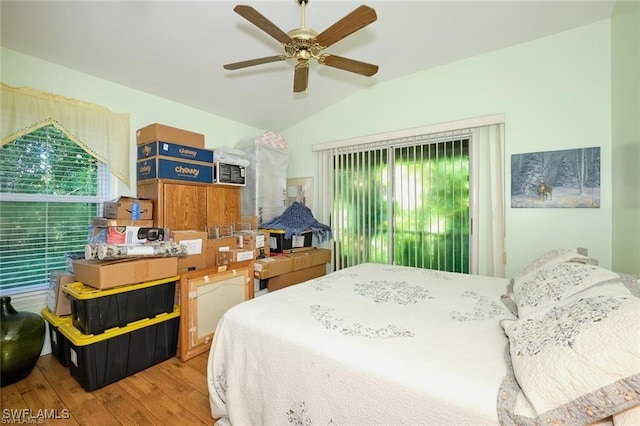 bedroom featuring ceiling fan, wood-type flooring, and lofted ceiling