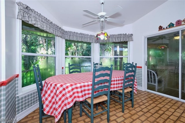 sunroom featuring vaulted ceiling, ceiling fan, and a healthy amount of sunlight