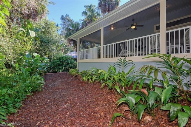 view of side of property featuring ceiling fan