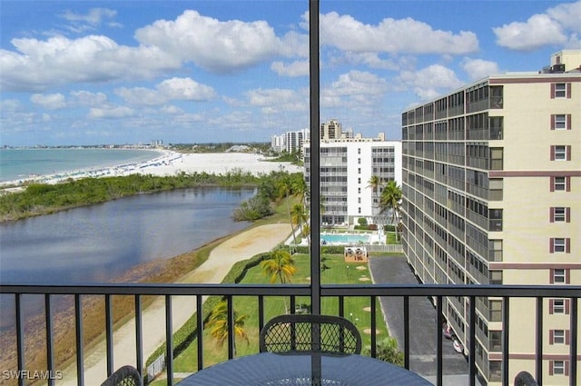 balcony with a water view and a beach view