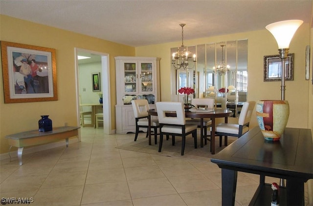 dining room with a notable chandelier and light tile patterned floors