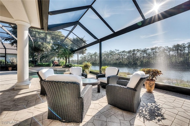 view of patio / terrace with a water view and glass enclosure