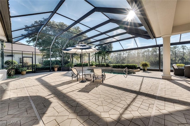 view of patio featuring glass enclosure