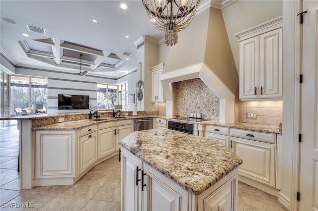 kitchen featuring light stone counters, hanging light fixtures, coffered ceiling, and kitchen peninsula