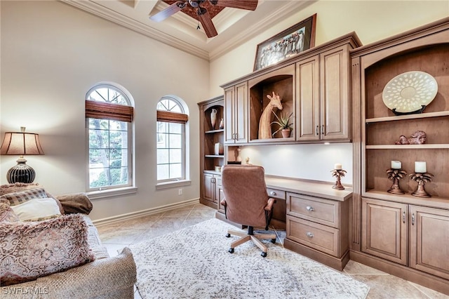 tiled office with built in desk, a high ceiling, ornamental molding, coffered ceiling, and ceiling fan