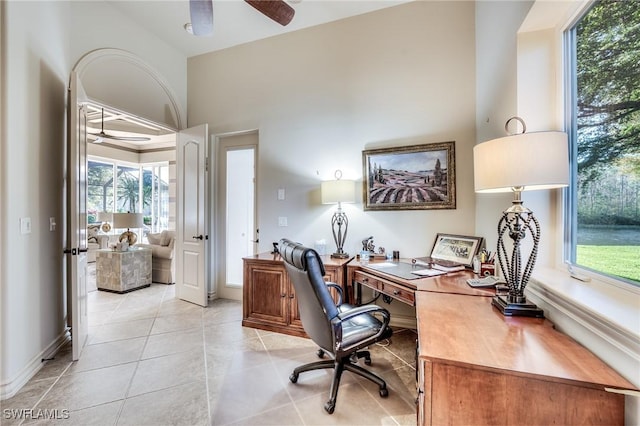 home office with ceiling fan, plenty of natural light, and light tile patterned floors