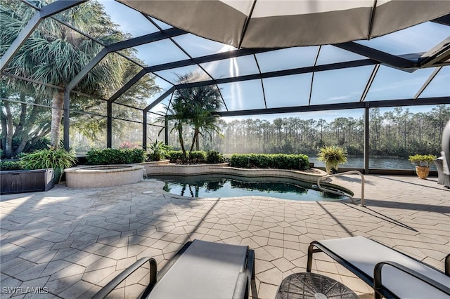 view of swimming pool with a patio, a water view, an in ground hot tub, and glass enclosure