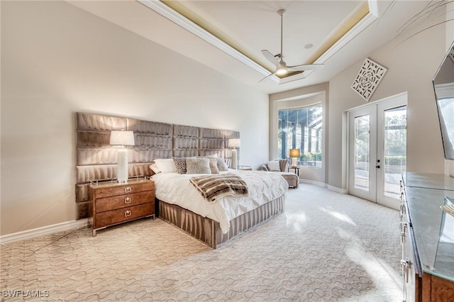 carpeted bedroom featuring a raised ceiling, access to outside, ceiling fan, and french doors