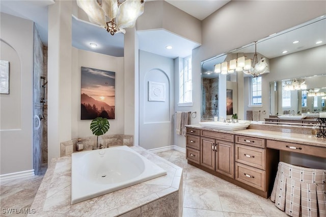 bathroom with vanity, a chandelier, and separate shower and tub