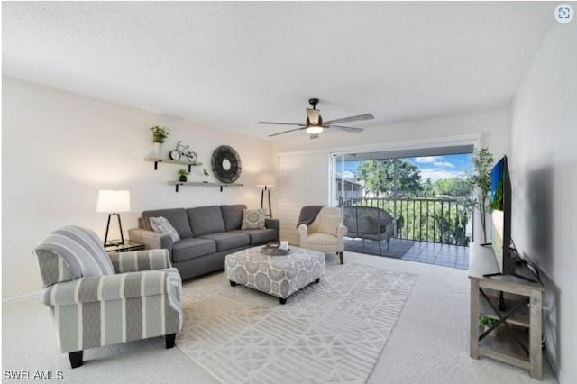 living area with ceiling fan and light carpet