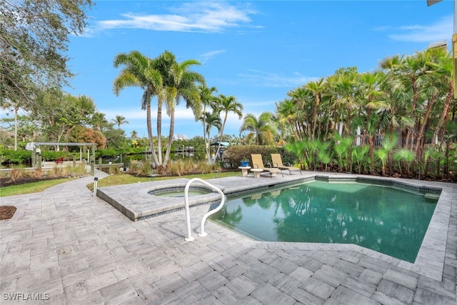 view of swimming pool featuring an in ground hot tub and a patio