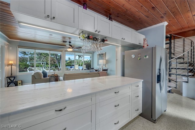 kitchen with white cabinetry, wooden ceiling, light stone counters, and stainless steel fridge with ice dispenser