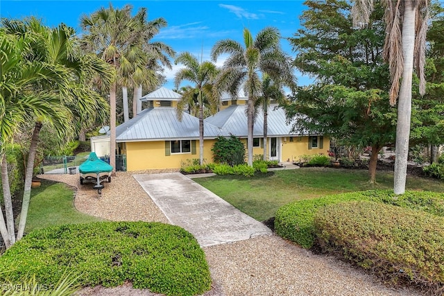 ranch-style home featuring a front yard