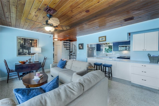 living room featuring sink, wood ceiling, and ceiling fan