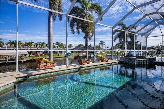 view of pool featuring a water view, an in ground hot tub, and glass enclosure