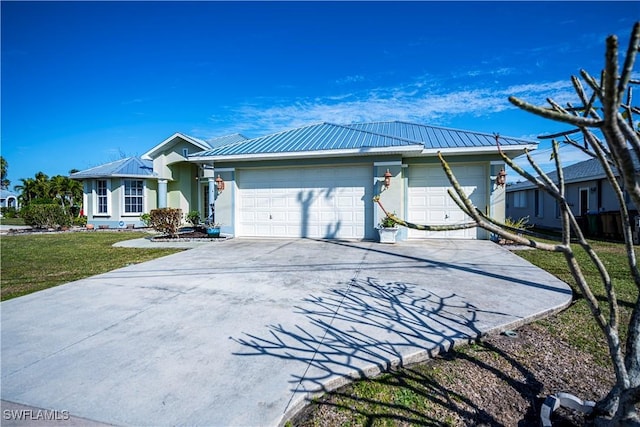 view of front of property with a garage and a front lawn