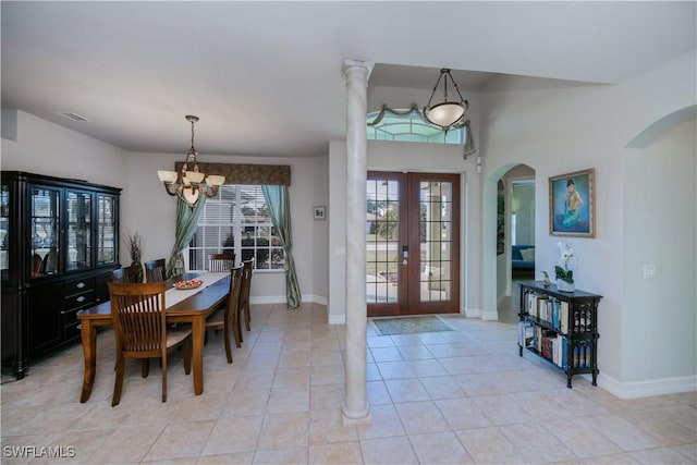 dining space featuring light tile patterned floors, an inviting chandelier, and french doors