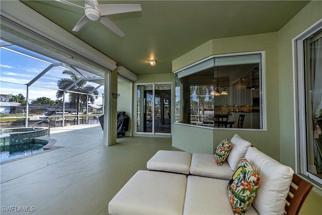 view of patio featuring glass enclosure and an in ground hot tub