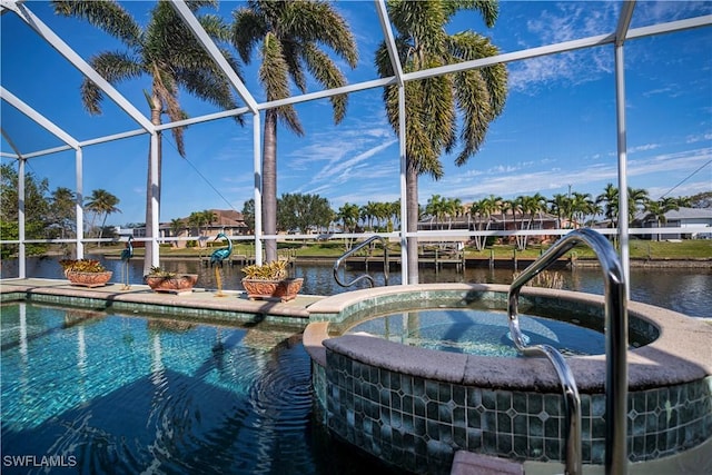 view of swimming pool with an in ground hot tub, a water view, and glass enclosure