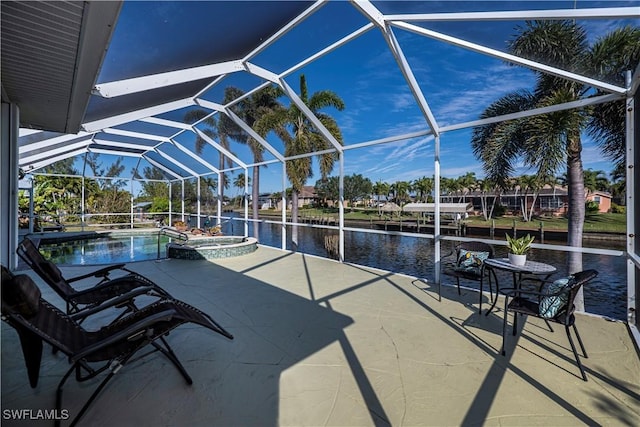 view of patio with a water view, a lanai, and a swimming pool with hot tub