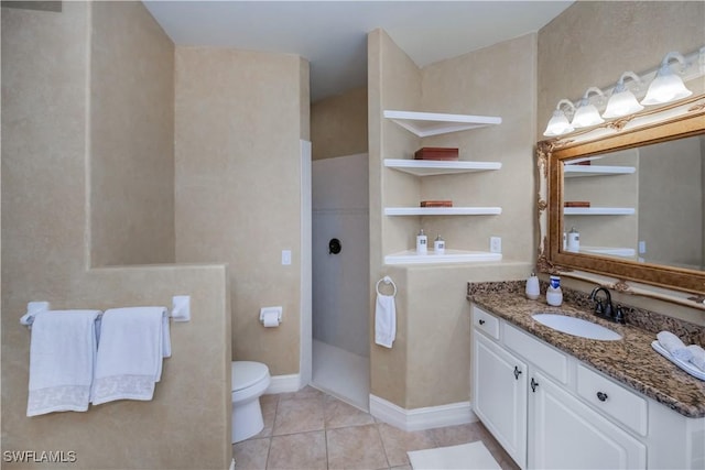 bathroom with built in shelves, tile patterned floors, toilet, and vanity