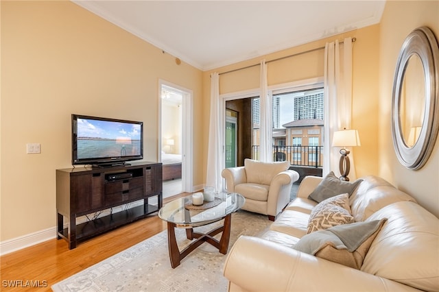 living room with light hardwood / wood-style flooring and ornamental molding