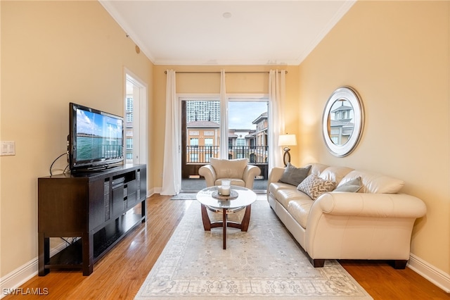 living room featuring crown molding and hardwood / wood-style floors