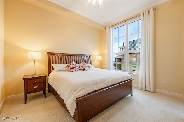 carpeted bedroom with ceiling fan, crown molding, and multiple windows