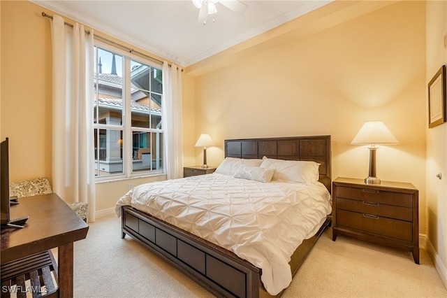 carpeted bedroom with ceiling fan and crown molding