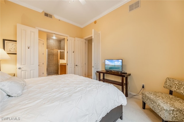 bedroom featuring ceiling fan, ornamental molding, connected bathroom, and carpet flooring