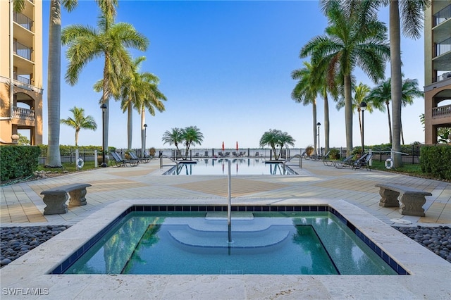 view of pool featuring a water view