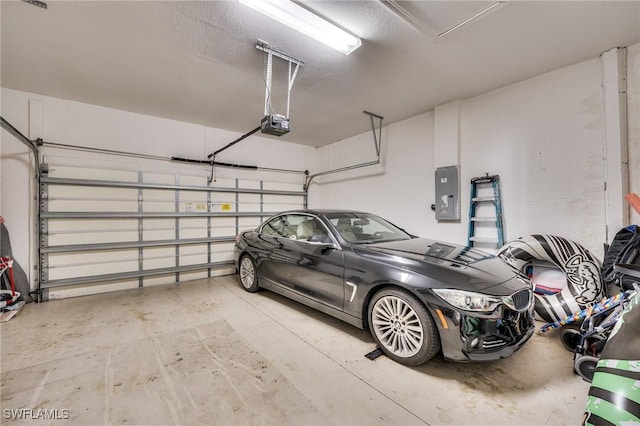 garage with a garage door opener and electric panel