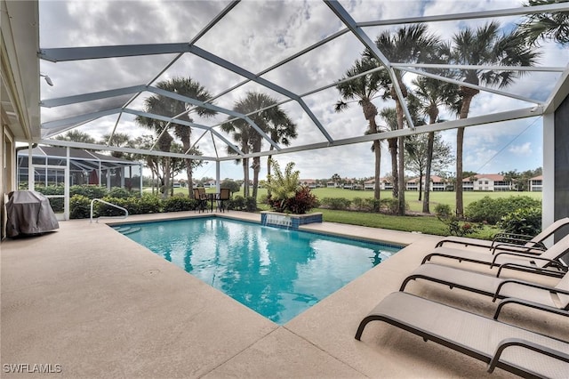 view of pool featuring a patio area, a lanai, a grill, and pool water feature