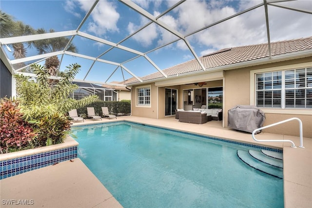 view of swimming pool with a lanai, an outdoor living space, a patio area, and grilling area