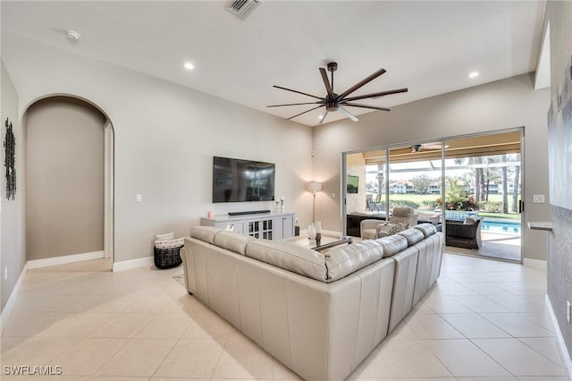 living room with ceiling fan and light tile patterned floors