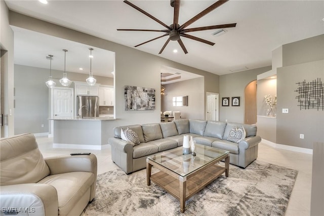 tiled living room with ceiling fan