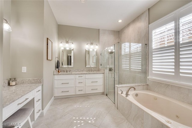 bathroom with vanity and independent shower and bath