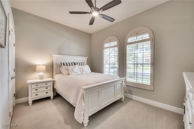 bedroom featuring ceiling fan and light carpet