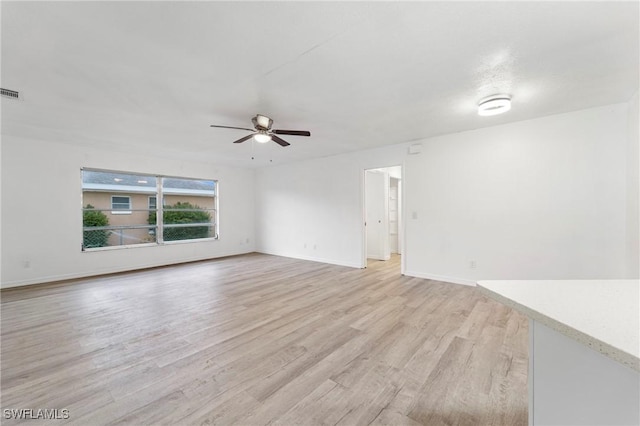 unfurnished room with ceiling fan and light hardwood / wood-style flooring