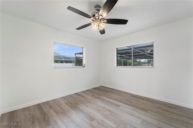 empty room with light hardwood / wood-style flooring and ceiling fan