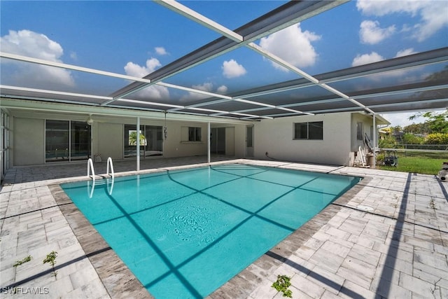 view of swimming pool with a lanai and a patio