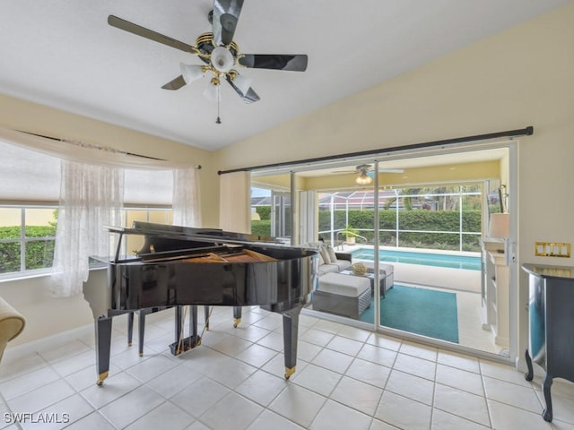 miscellaneous room featuring ceiling fan, vaulted ceiling, and light tile patterned flooring